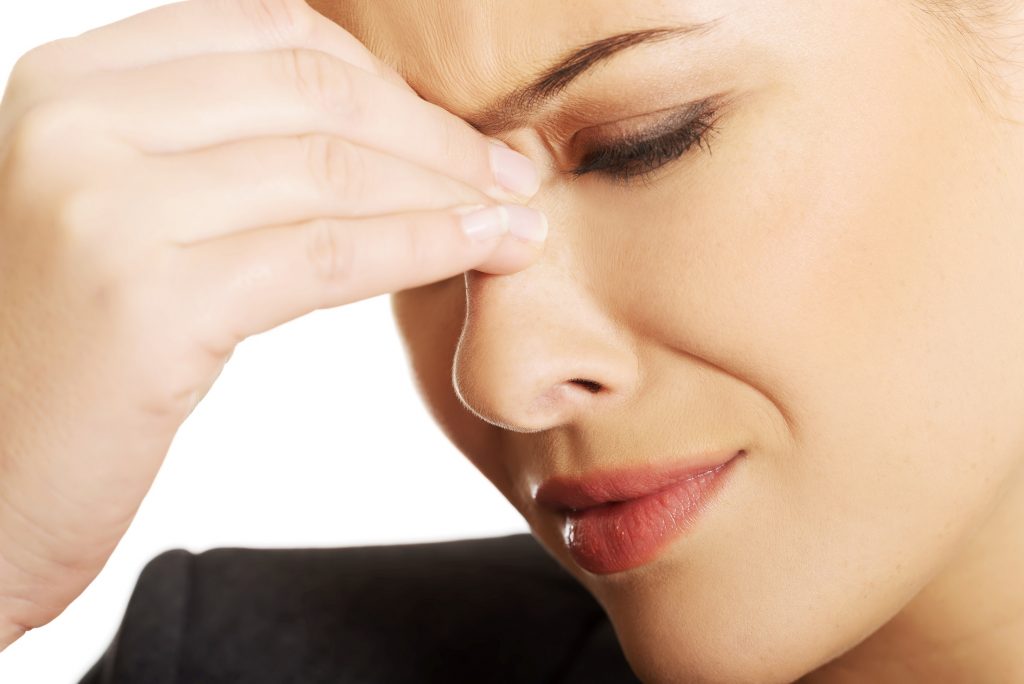 Young woman with sinus pressure pain